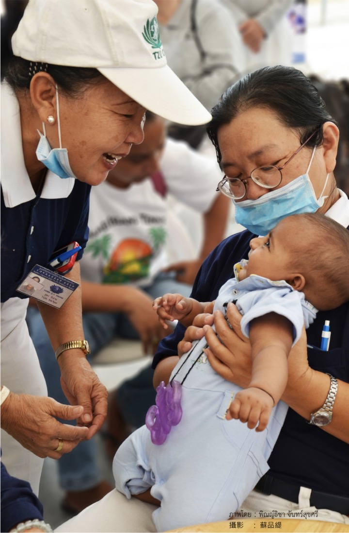Volunteer assisting a patient with a wheelchair